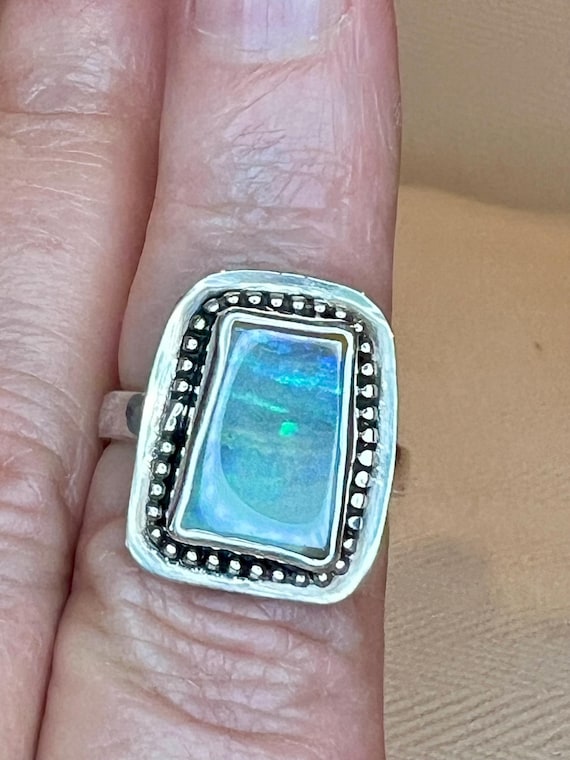 Framed rainbow of color boulder opal ring