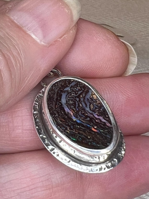 Boulder opal pendant with flashes of red