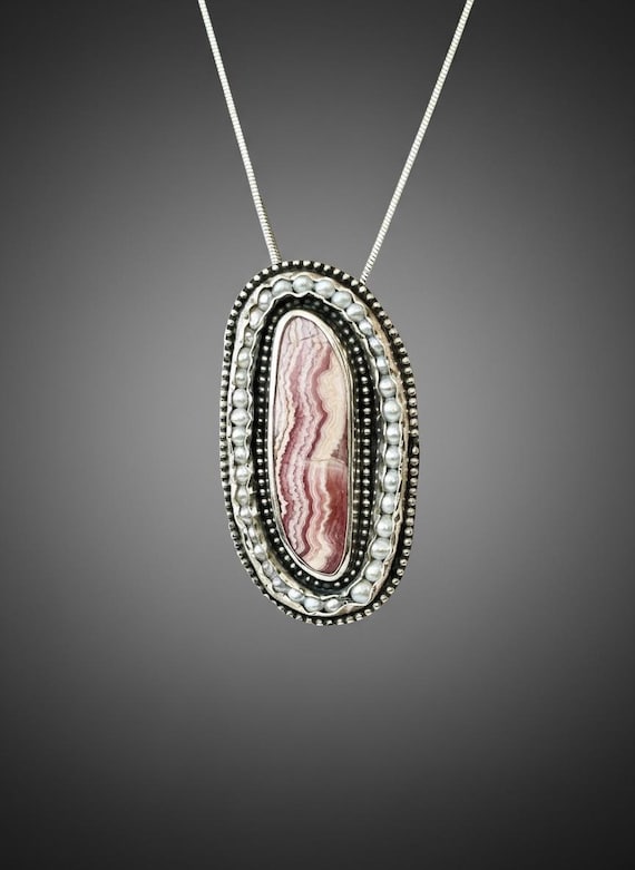 Rhodochrosite wrapped in fresh water pearls a beaded silver frame pendant