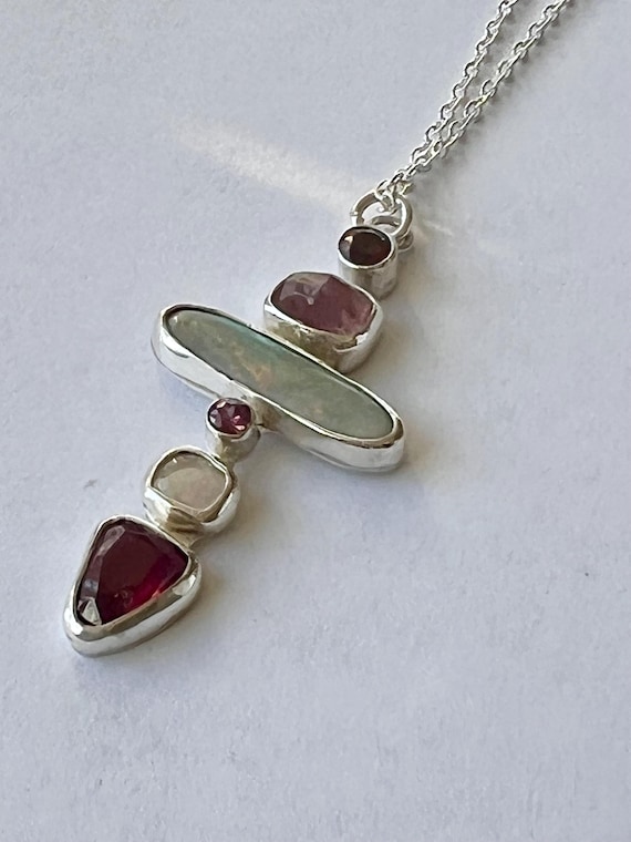 Multiple stone cross pendant