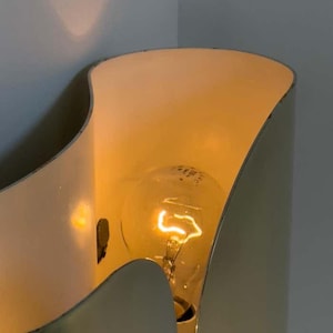 Inspired by iconic mid-century Italian design, the Foglio Wall Sconce brings refined elegance and architectural presence to any interior. Crafted from solid brass with a luxurious Italian gold finish, this sculptural sconce evokes the graceful fold of paper—its name, Foglio, meaning “sheet” in Italian.