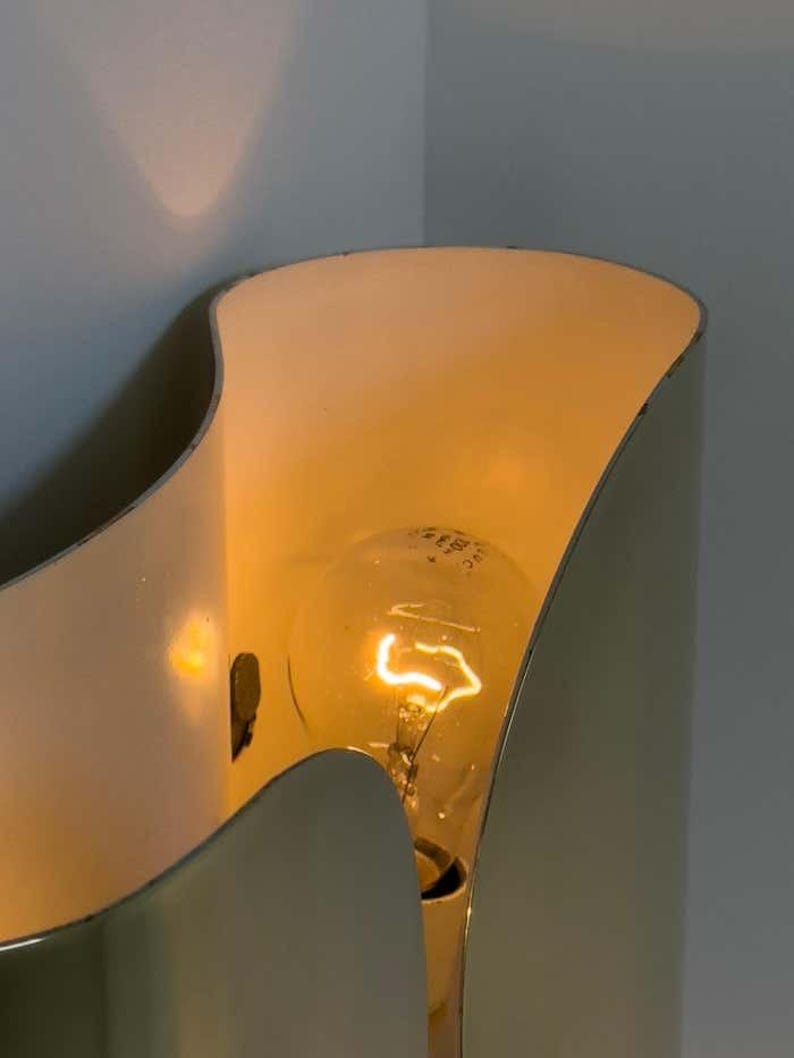 Inspired by iconic mid-century Italian design, the Foglio Wall Sconce brings refined elegance and architectural presence to any interior. Crafted from solid brass with a luxurious Italian gold finish, this sculptural sconce evokes the graceful fold of paper—its name, Foglio, meaning “sheet” in Italian.