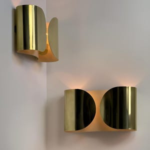 Inspired by iconic mid-century Italian design, the Foglio Wall Sconce brings refined elegance and architectural presence to any interior. Crafted from solid brass with a luxurious Italian gold finish, this sculptural sconce evokes the graceful fold of paper—its name, Foglio, meaning “sheet” in Italian.