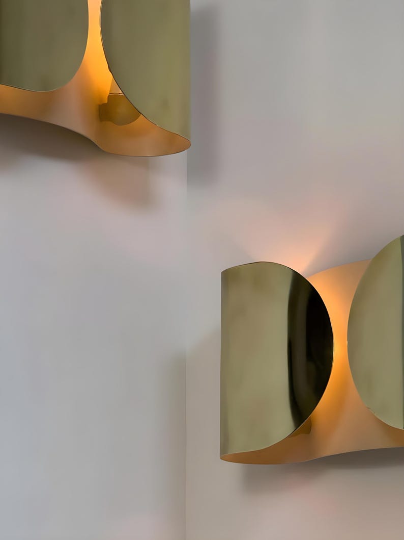 Inspired by iconic mid-century Italian design, the Foglio Wall Sconce brings refined elegance and architectural presence to any interior. Crafted from solid brass with a luxurious Italian gold finish, this sculptural sconce evokes the graceful fold of paper—its name, Foglio, meaning “sheet” in Italian.