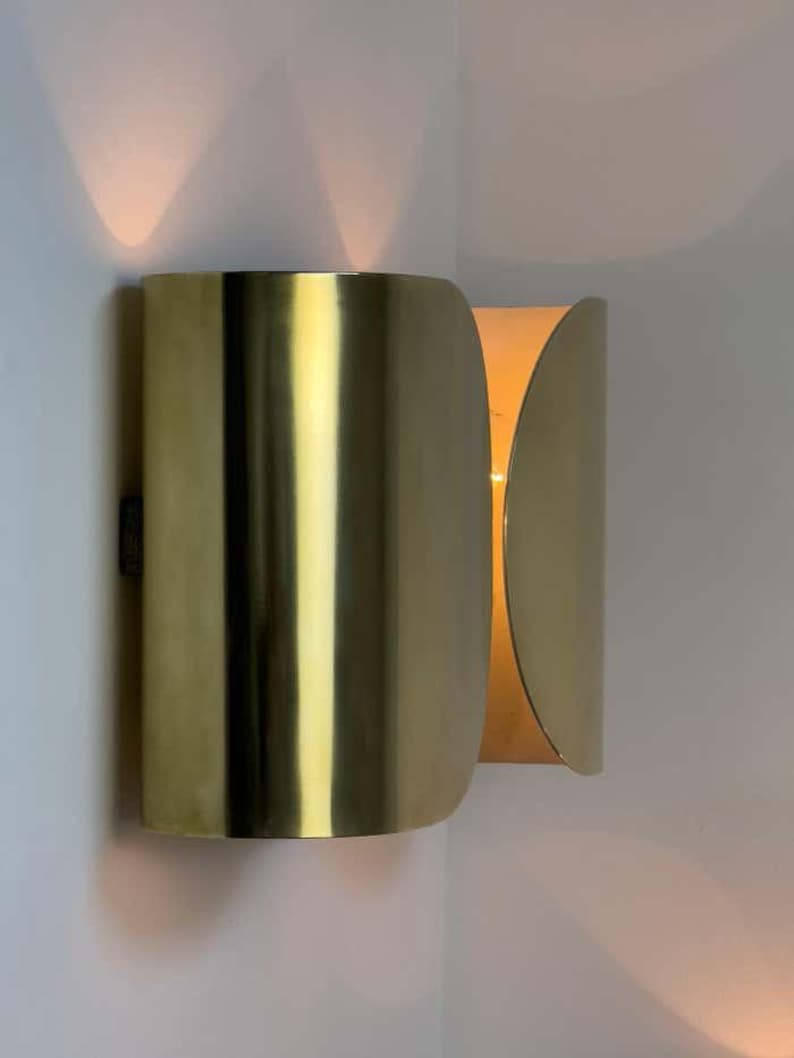 Inspired by iconic mid-century Italian design, the Foglio Wall Sconce brings refined elegance and architectural presence to any interior. Crafted from solid brass with a luxurious Italian gold finish, this sculptural sconce evokes the graceful fold of paper—its name, Foglio, meaning “sheet” in Italian.