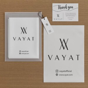 May include: A set of white branded packaging and stationery from "VAYAT". The set includes a mailing bag, a tag, a thank you card, and a large square bag. The brand's logo and social media details are printed in black.