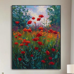 May include: Large framed oil painting depicting a field of red poppies. The artwork shows a green and orange background with a blue sky. The painting is displayed in a modern living room with white walls and furniture.