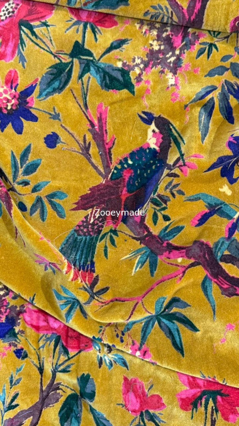 May include: Mustard yellow fabric with a vibrant floral and bird pattern. The design features colorful birds perched on branches with pink flowers and teal leaves. The text "Zooeymade" is visible on the fabric.