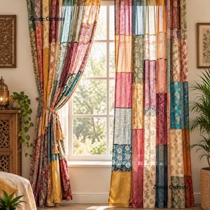 May include: A pair of floor-length curtains featuring a patchwork design with various floral and geometric patterns in shades of red, yellow, blue, green, and purple. The curtains are hung on a rod, with one side tied back, and display the text Zooey-Curtains.