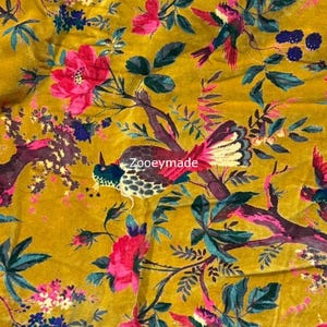 May include: Mustard yellow fabric with a floral and bird pattern. The design features pink flowers, teal leaves, and birds with white, teal, and red feathers. The text "Zooeymade" is visible on the fabric.