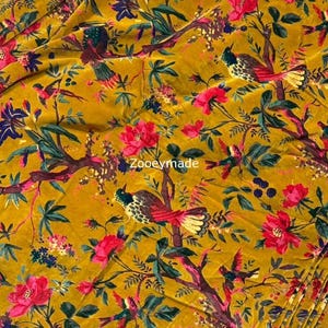 May include: Mustard yellow fabric with a vibrant floral and bird pattern. The design features red and pink flowers, green leaves, and colorful birds on branches. The text "Zooyemade" is visible.