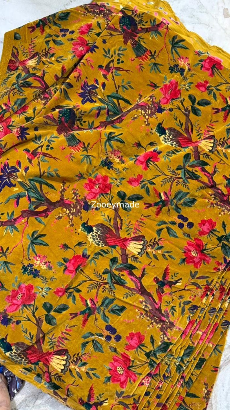 May include: Mustard yellow fabric with a vibrant floral and bird pattern. The design features red and pink flowers, green leaves, and colorful birds on branches. The text "Zooyemade" is visible.