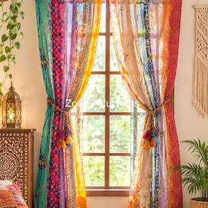 May include: A pair of window curtains featuring vertical panels of multicolored fabric with various floral and geometric patterns. The curtains are hung on a copper rod with fabric tabs and are tied back with braided cords featuring tassels.