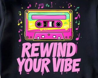 May include: Black hoodie featuring a retro cassette tape design in pink, yellow, and green, with musical notes scattered around. The phrase "REWIND YOUR VIBE" is printed in pink below the cassette.