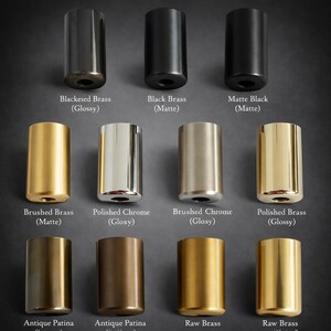 May include: A collection of cylindrical metal objects in various finishes, including black, brass, and chrome. The image displays options like "Blackened Brass (Glossy)" and "Polished Chrome (Glosy)". The objects are arranged against a dark background.