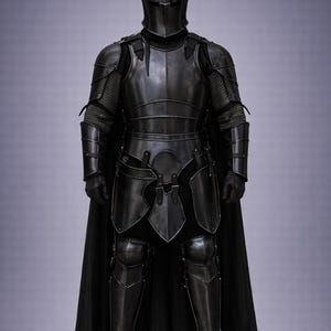 May include: Full suit of black medieval armor, including a helmet, chest plate, and leg guards. The armor has a dark, metallic finish and is worn with a black cape. The design is detailed and appears to be functional.