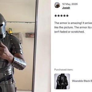 May include: A person wearing a black knight armor suit, including a helmet, chest plate, and arm guards. The armor has a metallic sheen and is detailed with rivets and straps. The suit is designed to be wearable.
