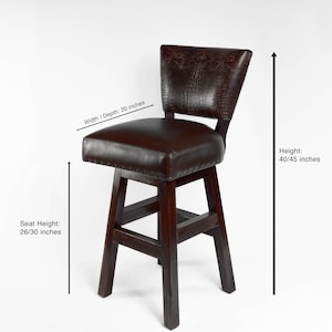 May include: Dark brown bar stool with a leather seat and backrest. The seat is 20 inches wide/deep, with a seat height of 26/30 inches, and a total height of 40/45 inches. The backrest has a textured pattern.
