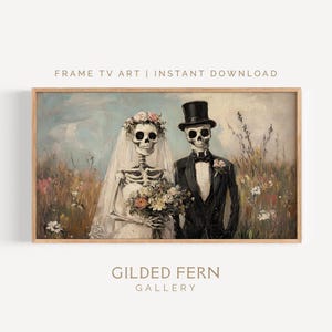 May include: A framed print featuring a skeletal bride and groom in a field of wildflowers. The bride wears a veil and floral crown, holding a bouquet. The groom wears a tuxedo and top hat. The text "FRAME TV ART | INSTANT DOWNLOAD" and "GILDED FERN GALLERY" are visible.