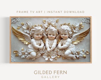 May include: A framed digital art print featuring three cherubic figures with golden wings and floral accents. The artwork has a light color palette with gold and white details. The text "FRAME TV ART | INSTANT DOWNLOAD" and "GILDED FERN GALLERY" are visible.