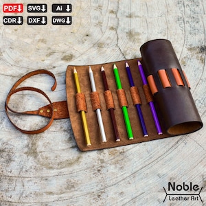 May include: A brown leather pencil roll with a strap, holding several colored pencils. The roll is partially open, revealing the pencils in a row. The pencils are yellow, white, brown, green, blue, and purple. The logo "Noble Leather Art" is in the bottom right corner.