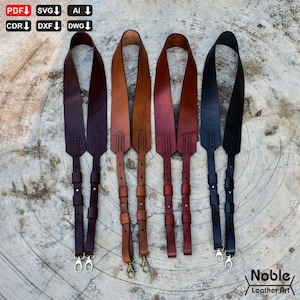 May include: Five leather camera straps in various colors: dark burgundy, tan, reddish-brown, and black. Each strap has a different metal clasp and is designed for attaching to a camera. The straps are displayed on a textured, light-colored surface.