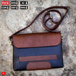 May include: A two-tone leather bag with a brown flap and a navy blue body. The bag has a brown shoulder strap and a small brown accent on the front. The bag has the text "Noble Leather Art" on the bottom right.