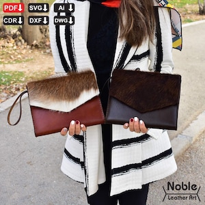 May include: Two leather clutch bags. One is brown with a white and brown fur flap, the other is dark brown with a dark brown fur flap. Both have a wrist strap. The bags are held in front of a person wearing a black and white striped jacket. The text "Noble Leather Art" is visible.