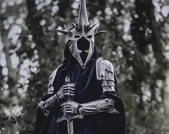 May include: A dark, metallic, spiked helmet with a pointed crown and a hollow face mask, worn with matching silver-toned articulated gauntlets and shoulder armor over a heavy black hooded cloak, while holding a long, straight metal sword.
