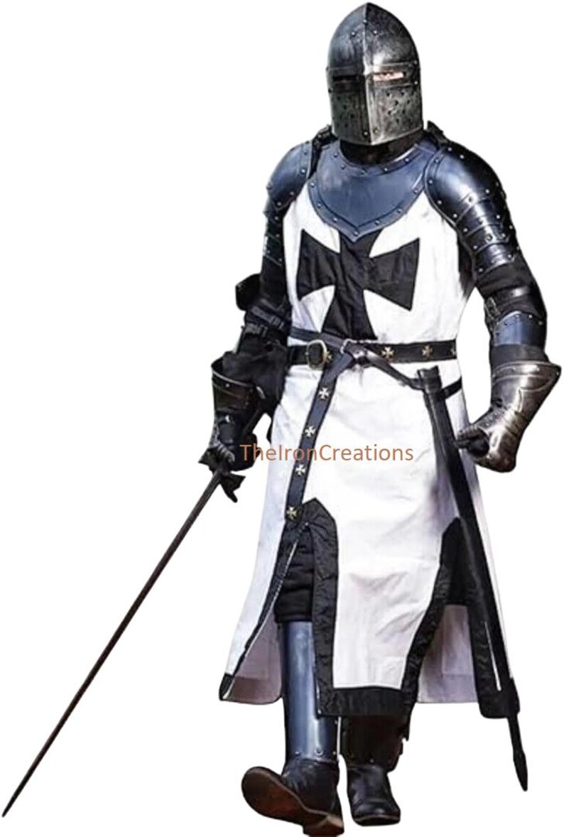 May include: A full suit of medieval knight armor, including a helmet, chest plate, and leg protection. The white tunic features a large black cross. The armor is detailed with metal accents and a black belt. A sword is held in the right hand.