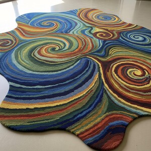 Irregular-shaped area rug featuring vibrant multicolor swirling abstract patterns in blue, green, yellow, red, and orange displayed on a smooth light floor.