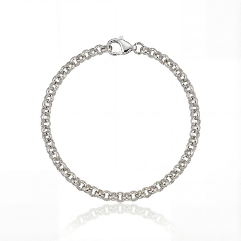 May include: A silver-colored bracelet with a circular chain design. The bracelet has a lobster clasp closure. The jewelry is displayed on a white background.