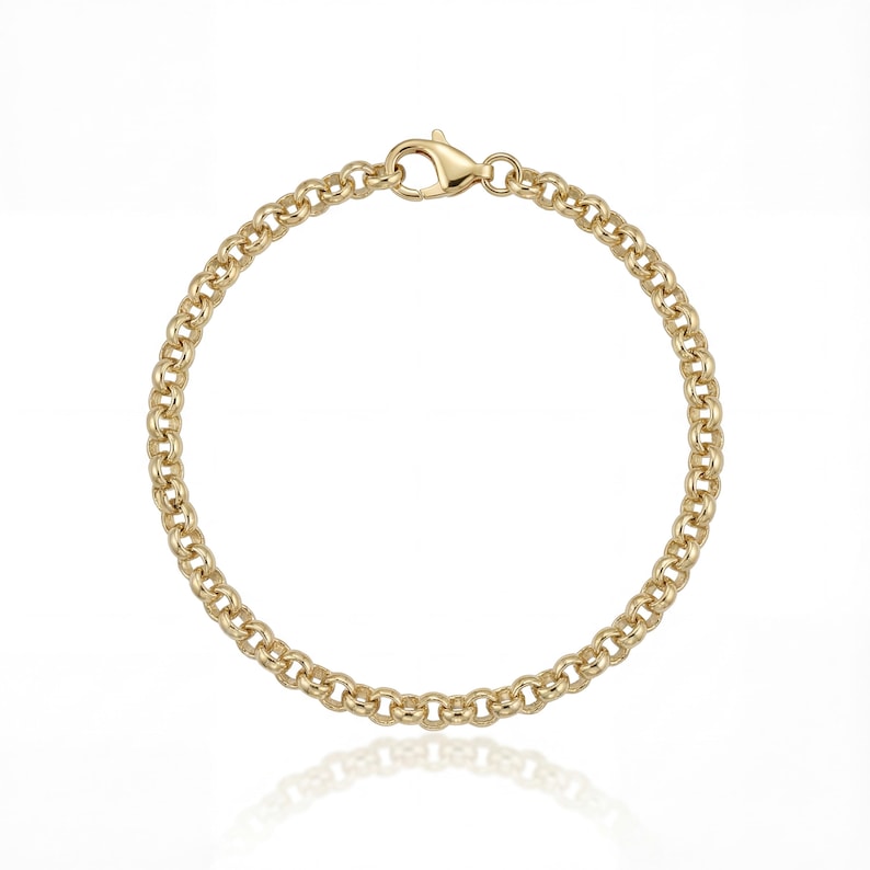 May include: A gold-colored chain bracelet with a lobster clasp. The bracelet is made of small, rounded links, creating a textured appearance. The clasp is also gold-toned and securely fastens the bracelet.