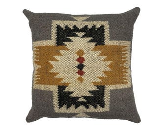 May include: Square decorative pillow with a geometric pattern. The pillow features a gray border and a central design in black, tan, cream, and red. The pillow is made of a textured fabric.