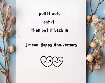 May include: A white card with the text "pull it out, eat it, then put it back in. I mean, Happy Anniversary." Two smiling heart illustrations are at the bottom. The card is on a blue background with floral accents.