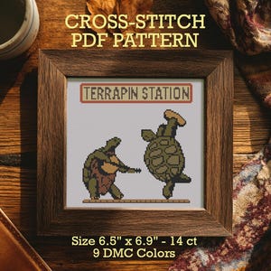 May include: A framed cross-stitch PDF pattern featuring two turtles. One turtle plays a stringed instrument, and the other dances. The text "TERRAPIN STATION" is above the turtles. The pattern size is 6.5" x 6.9" and uses 9 DMC colors.