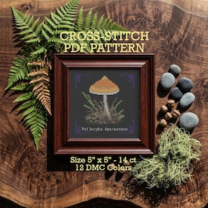 May include: A framed cross-stitch PDF pattern featuring a mushroom design. The artwork is displayed in a dark brown frame, with the text "CROSS-STITCH PDF PATTERN" at the top. The pattern size is 5" x 5" and uses 12 DMC colors.