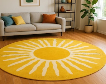 May include: A round yellow rug with a white sunburst design. The rug is placed on a hardwood floor in a living room setting, with a sofa, pillows, and decorative items in the background.