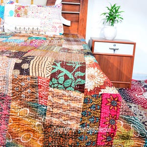 May include: A colourful patchwork quilt featuring floral and geometric patterns, displayed on a bed with a wooden headboard and a matching pillow. The text "Copyright of RamSiyaCollection" is visible on the quilt.