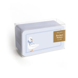 May include: A set of 50 pocket notes in a clear plastic box. The light blue cards feature a white goose with a blue ribbon around its neck, an orange beak and feet, and a blue and white checkered border. The label reads Inklings Pocket Notes Set of 50.