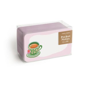 May include: A clear plastic box containing a set of 50 light purple pocket notes. The front label features the text Inklings Pocket Notes Set of 50 and an illustration of a green teacup with a floral pattern, a saucer, and a pink tea bag tag.