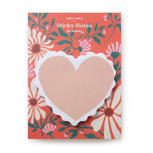 May include: A heart-shaped sticky note with a scalloped edge, set against a floral patterned background. The background is a vibrant red with white and pink flowers and green leaves. The text "INKLINGS Sticky Notes 50 Sheets" is printed at the top.