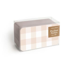 May include: A set of pocket notes in a clear plastic box. The notes have a light pink and white gingham pattern. The label on the box reads "INKLINGS Pocket Notes Set of 50".