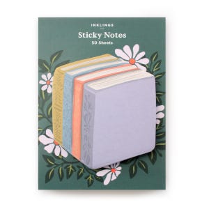 May include: A set of sticky notes shaped like colorful books. The notes are arranged on a dark green background with white daisy flowers and green leaves. The text "INKLINGS Sticky Notes 50 Sheets" is at the top.