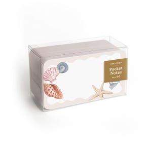 May include: A set of 50 pocket notes in a clear plastic box. The notes have a light pink border with seashell and starfish illustrations. The label reads "INKLINGS Pocket Notes Set of 50".