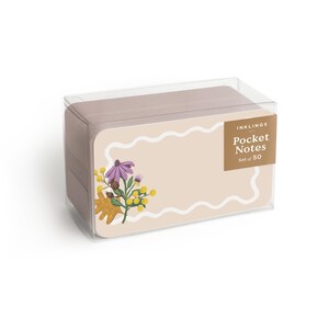 May include: A box of pocket notes with a floral design. The notes are a light tan color with a white wavy border. The floral design includes purple flowers, yellow buds, and a brown leaf. The box is clear plastic and the text "INKLINGS Pocket Notes Set of 50" is visible.