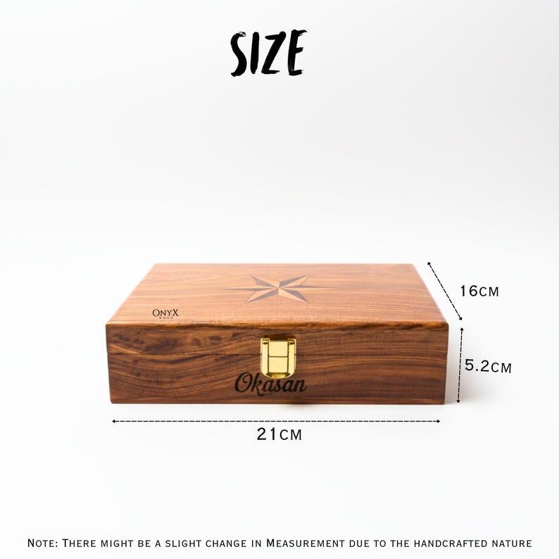May include: A rectangular wooden box with a compass rose design on the lid. The box is 8.27 inches long, 6.3 inches wide, and 2.05 inches high. It has a gold-colored clasp and the text "Okasan".