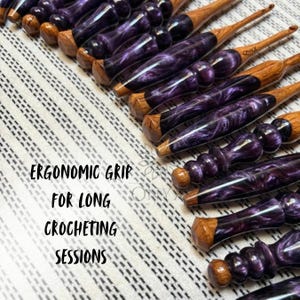 May include: A collection of handcrafted crochet hooks featuring polished wooden tips and ergonomic handles made from swirling purple and black resin. The text "ERGONOMIC GRIP FOR LONG CROCHETING SESSIONS" is printed on the left side of the image.