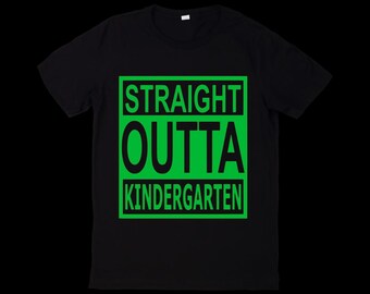 May include: Black t-shirt with the text "STRAIGHT OUTTA KINDERGARTEN" in a green box. The text is in a bold, sans-serif font. The shirt is a crew neck style.