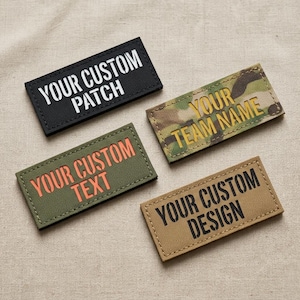 May include: Four rectangular patches with stitched borders. One black patch reads YOUR CUSTOM PATCH in white. One olive green patch reads YOUR CUSTOM TEXT in orange. One camouflage patch reads YOUR TEAM NAME in yellow. One tan patch reads YOUR CUSTOM DESIGN in black.